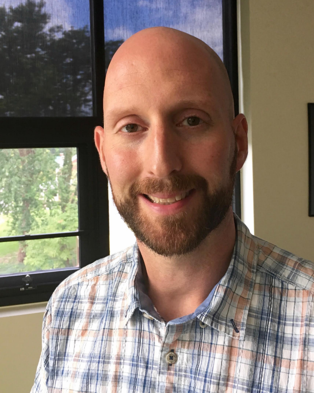 bald man with beard smiling