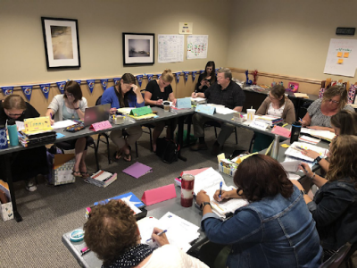 Teachers meetings around a round table set up