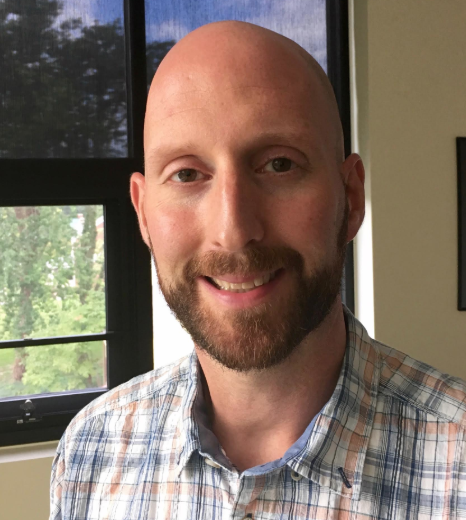 Bald man with a beard smiling