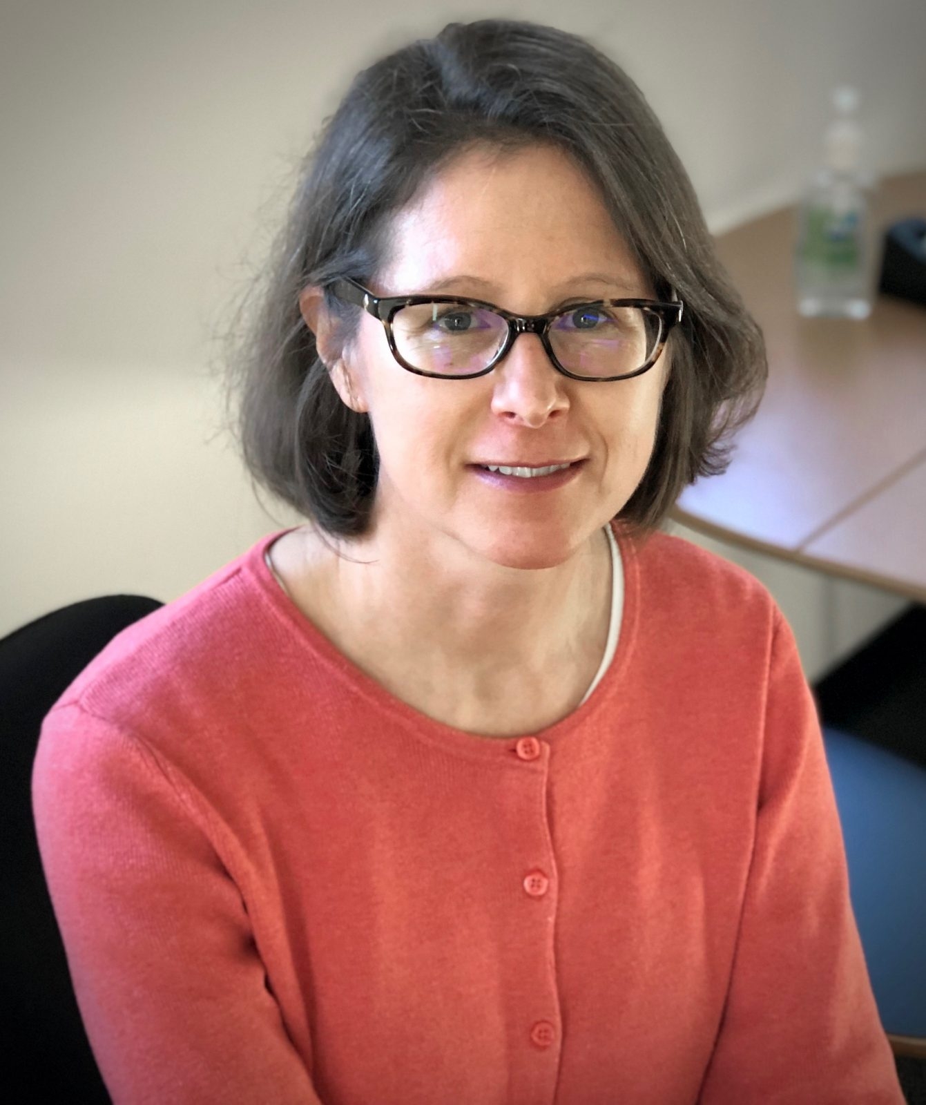 woman with short brown hair wearing glasses