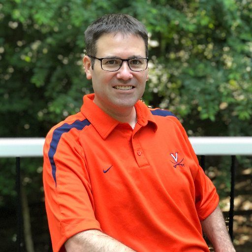 Man in orange university of virginia shirt and glasses